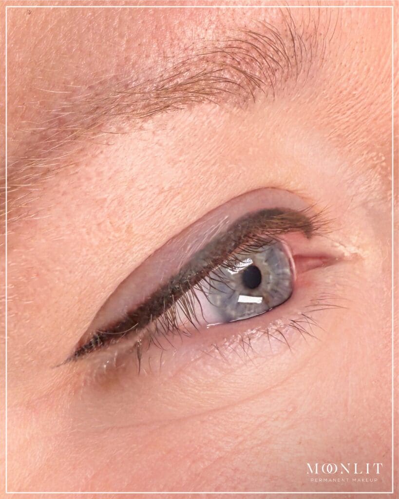 Close-up of healed brown permanent eyeliner tattoo along lash line showing soft natural definition and fuller lashes, cosmetic tattoo result by Salt Lake City PMU artist, Salt Lake City, Utah.