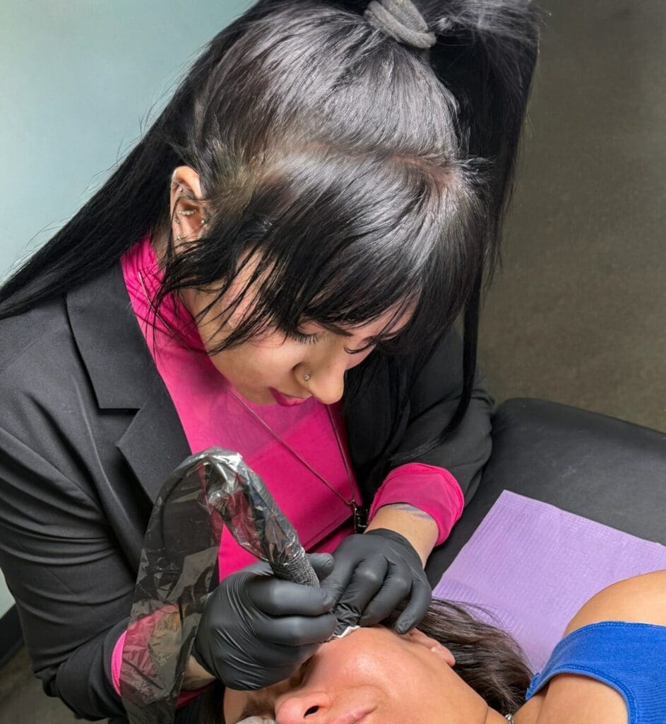 Salt Lake City PMU artist performing gender affirming permanent makeup procedure for client in professional studio, inclusive cosmetic tattooing in the United States