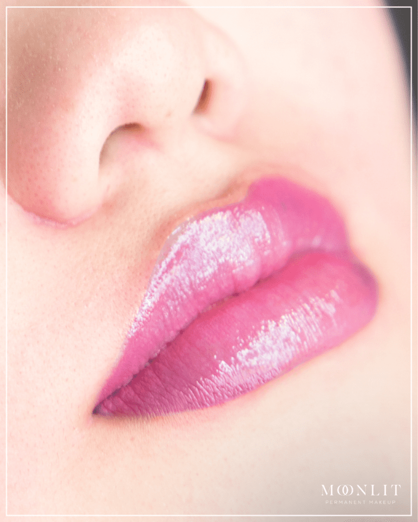Bright pink lip blush tattoo enhancing lip color and shine, smooth hydrated lips with defined shape by Salt Lake City PMU artist, glossy healed lip blush results, luxury permanent makeup in Salt Lake City Utah