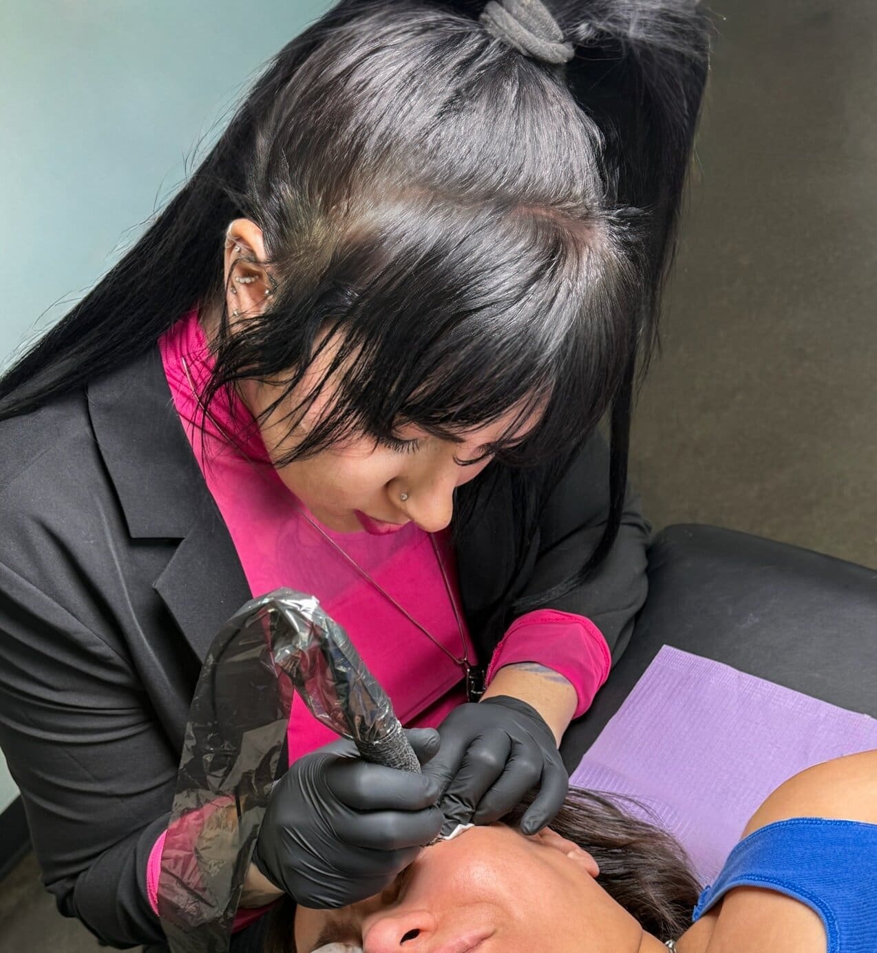 Salt Lake City permanent makeup artist performing detailed PMU procedure during client appointment